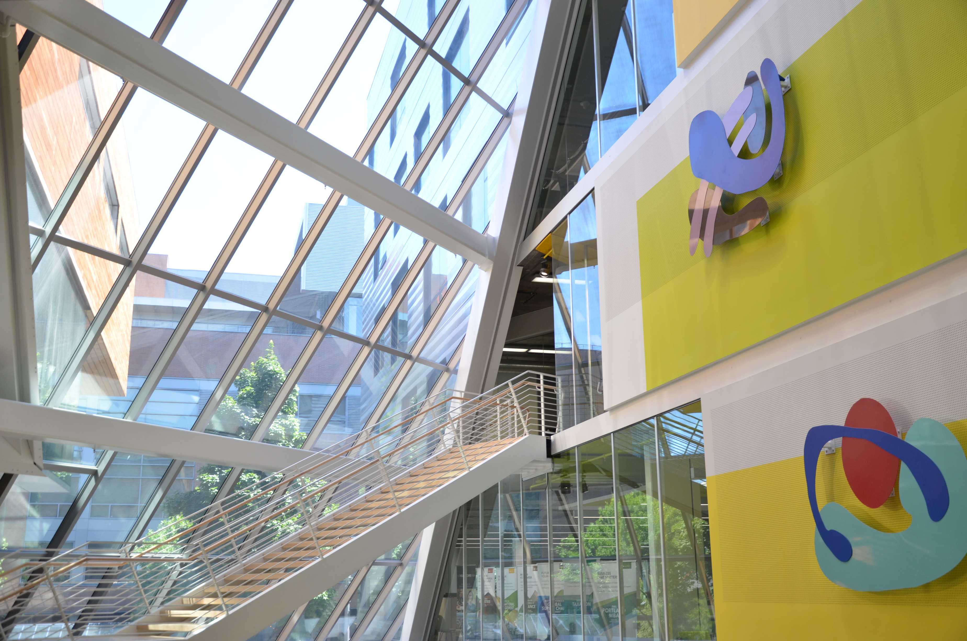 sculptures mounted on wall inside Karl Miller Center atrium